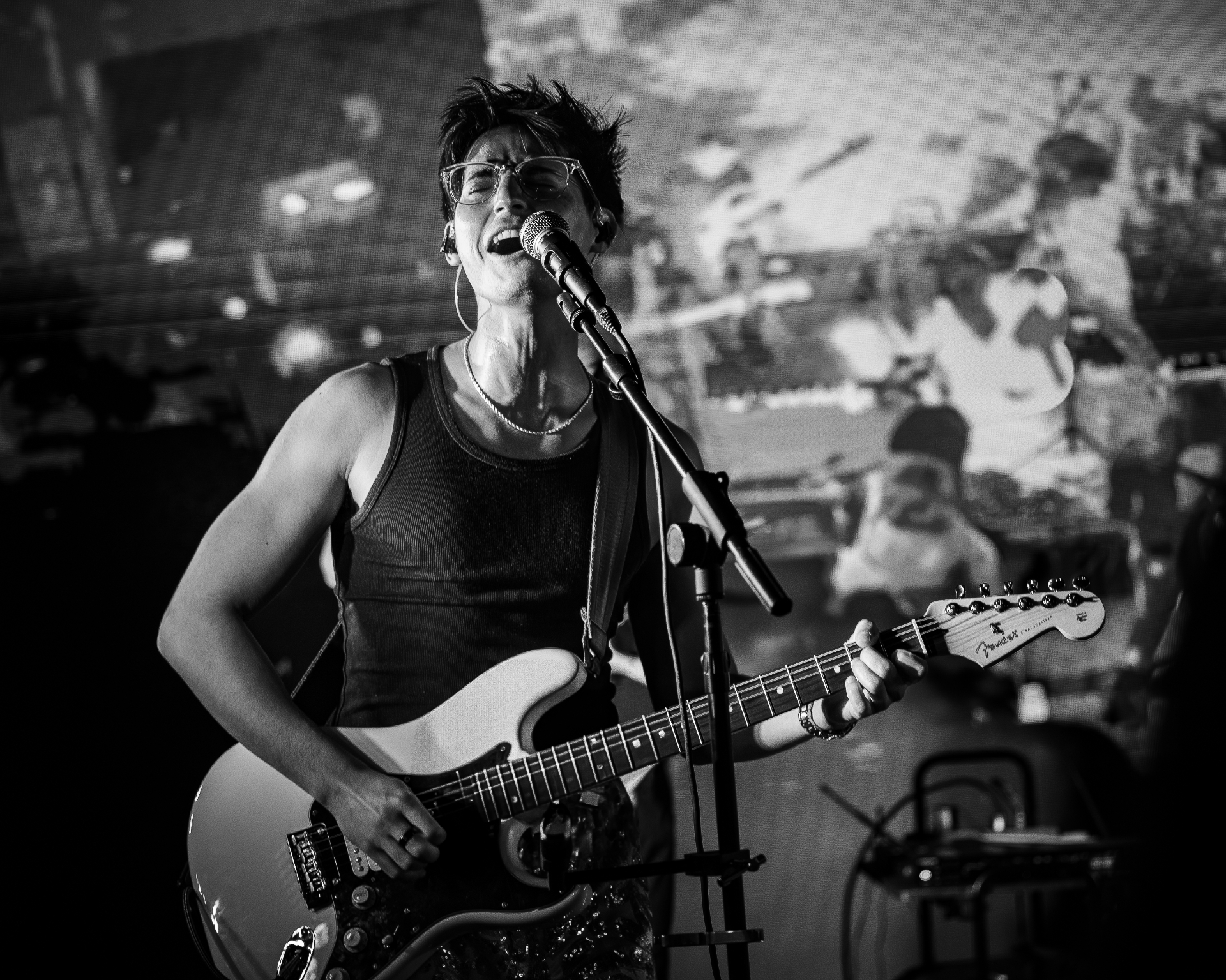 Manix Rho vocalist singing and playing Fender Stratocaster live